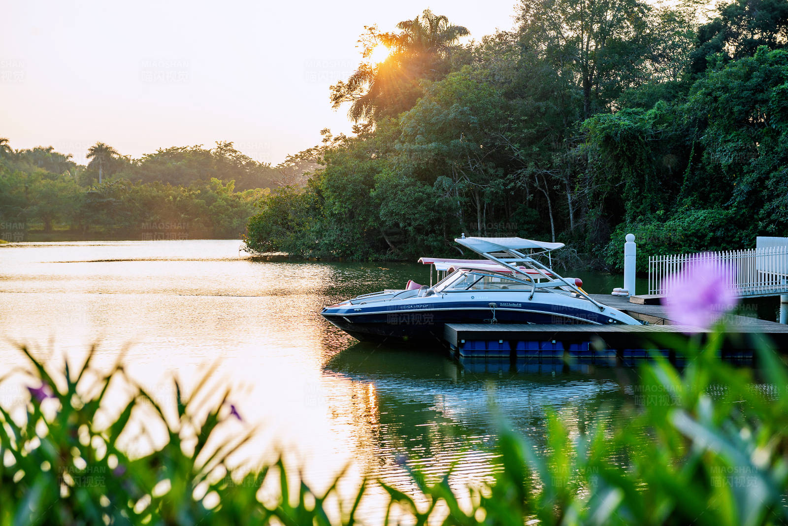湖畔夕阳下的游艇图片