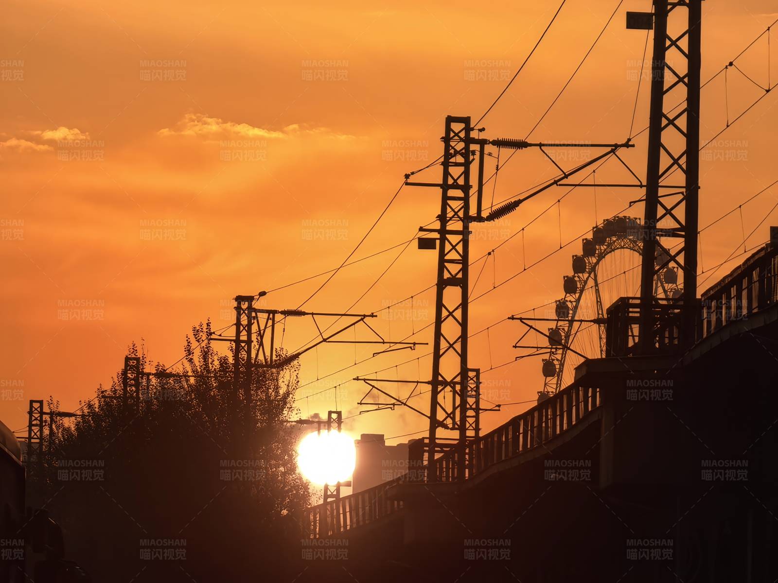 夕阳下的铁路和摩天轮图片