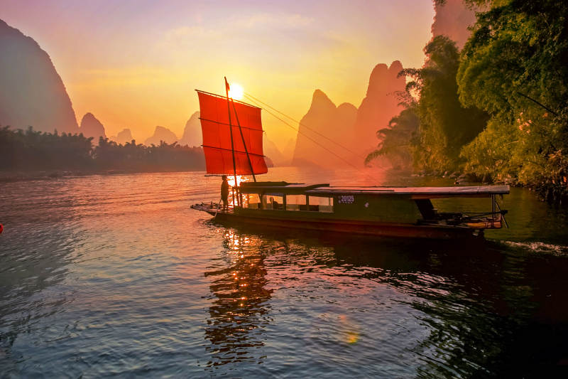 漓江夕阳红帆船图片