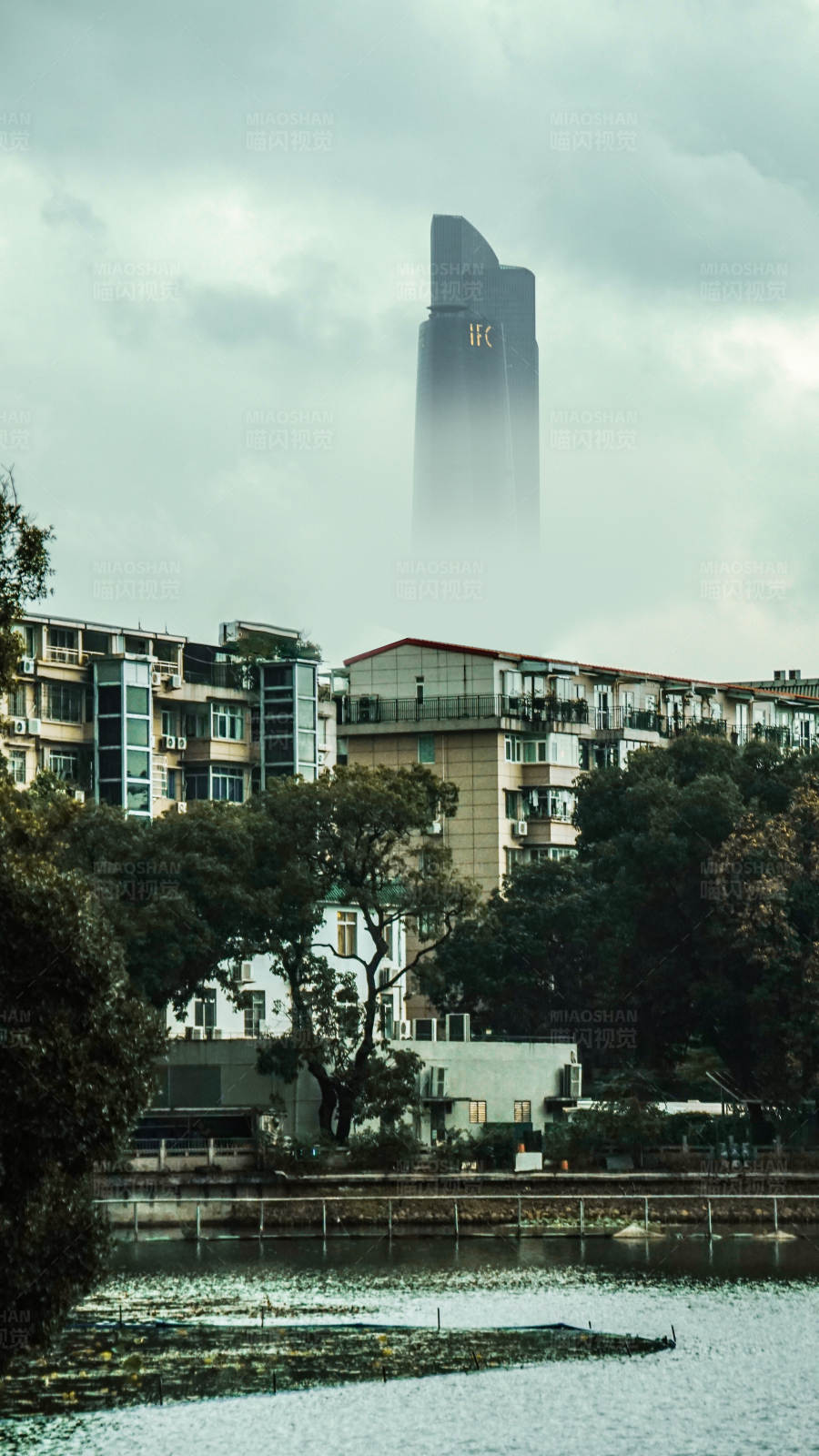 雾中摩天大楼与河景图片