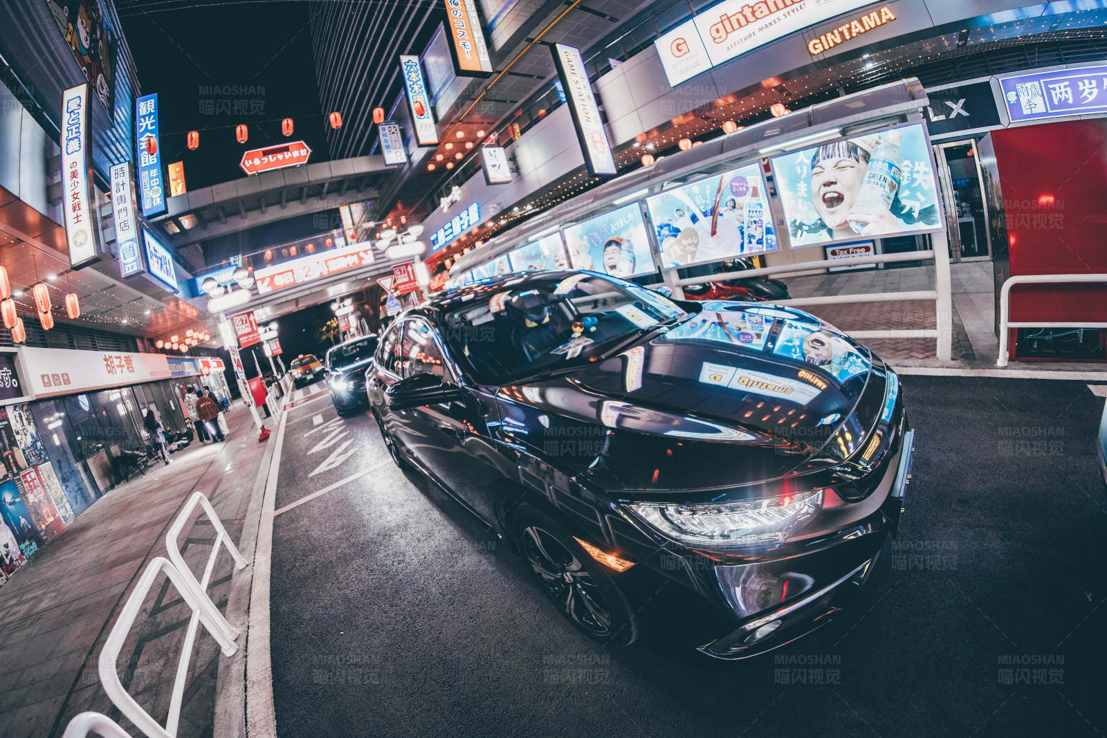 霓虹夜景中的黑色轿车图片