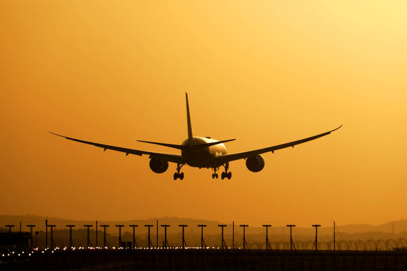 夕阳下的飞机降落图片