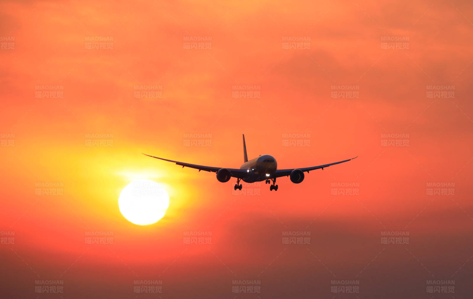 夕阳下的飞机降落图片