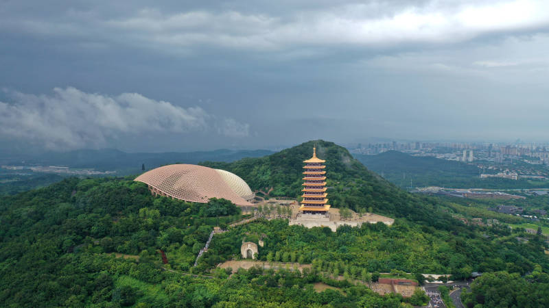 航拍雨后山巅古塔与现代建筑图片