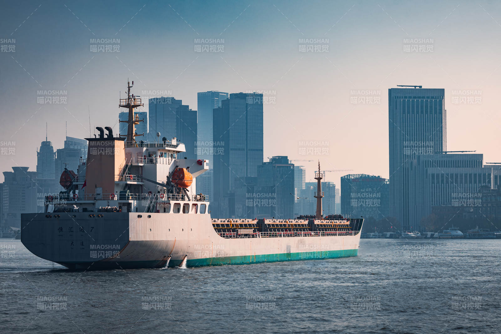 城市天际线前的货船图片