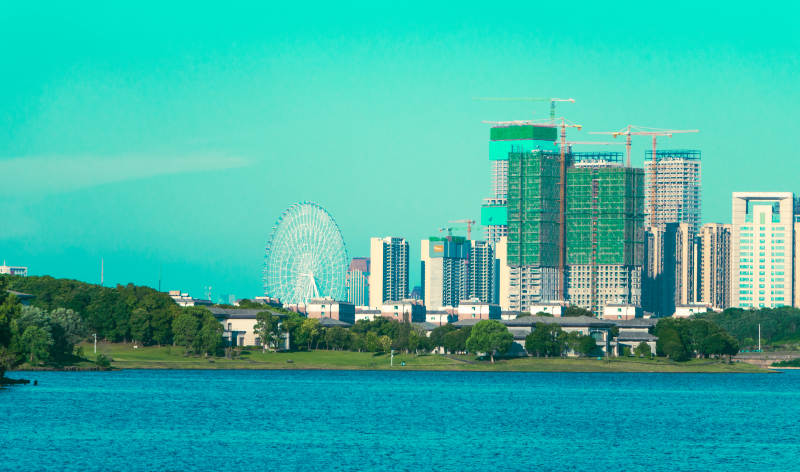 湖畔摩天轮与城市天际线图片