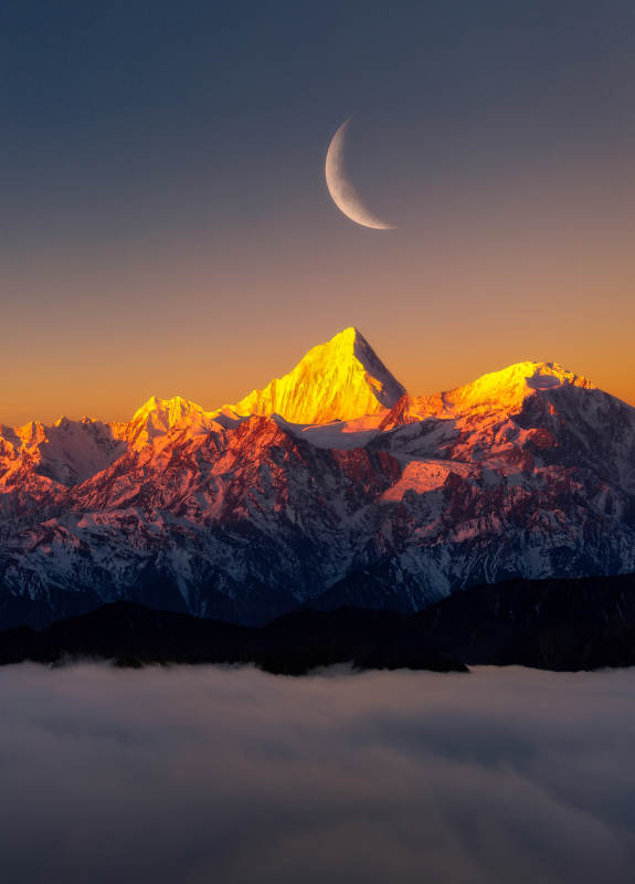 雪山日落 新月高悬图片