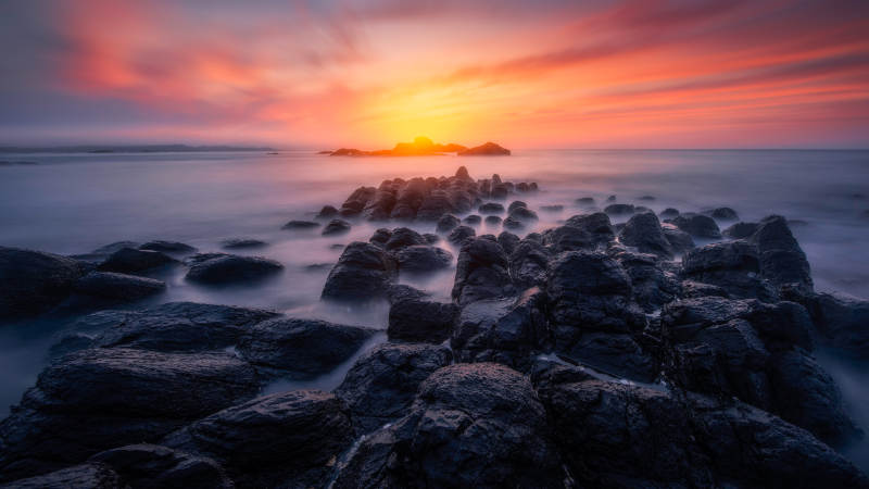 夕阳下的岩石海岸图片