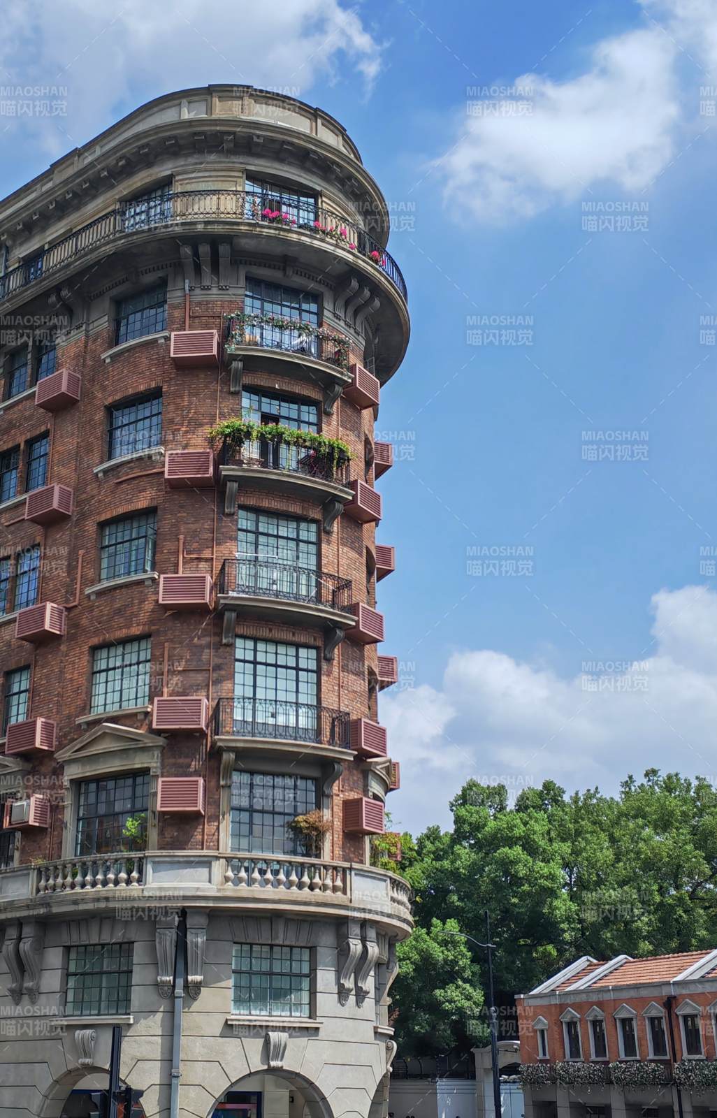 复古红砖建筑与蓝天绿树图片