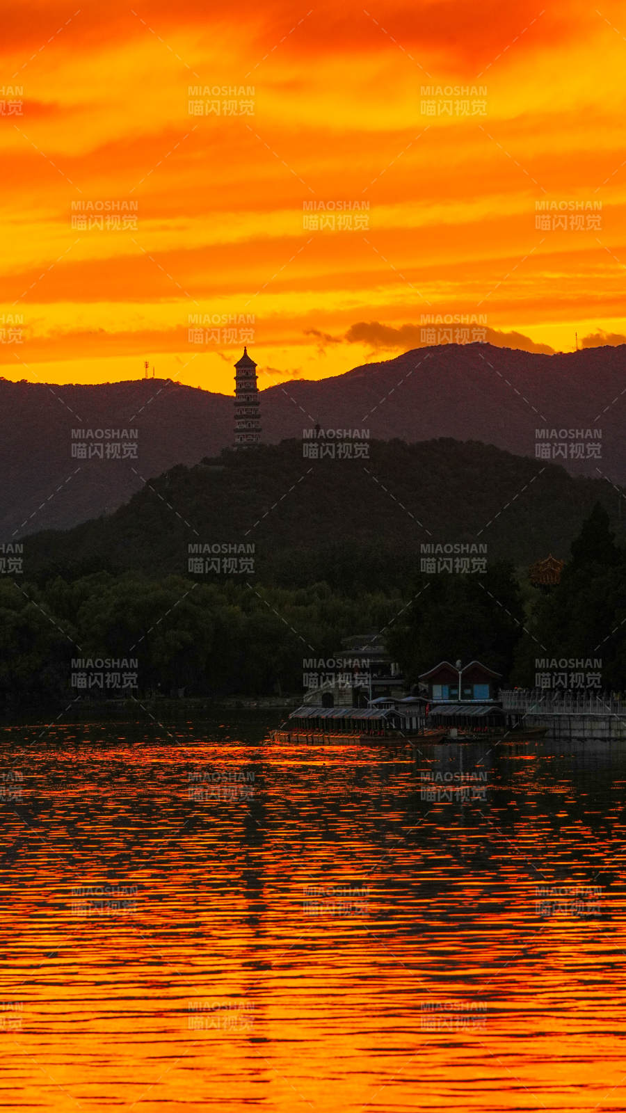 夕阳映照湖畔塔影图片