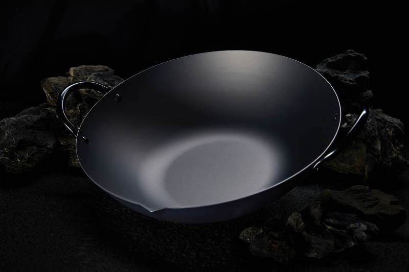 黑色铁锅静置于暗处图片