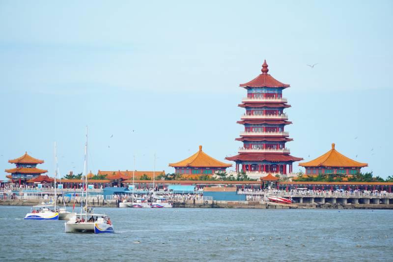 海边古塔与帆船风景位于烟台市蓬莱景区图片