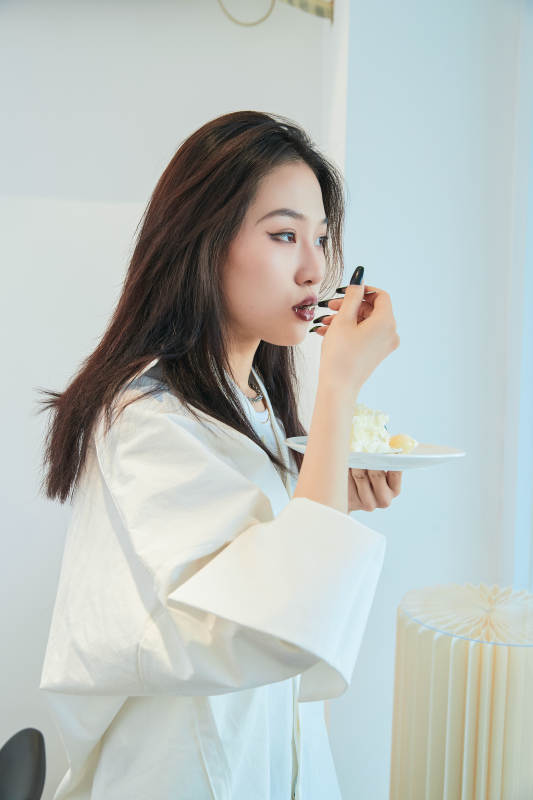 在烘焙店吃蛋糕喝饮料的可爱亚洲少女图片