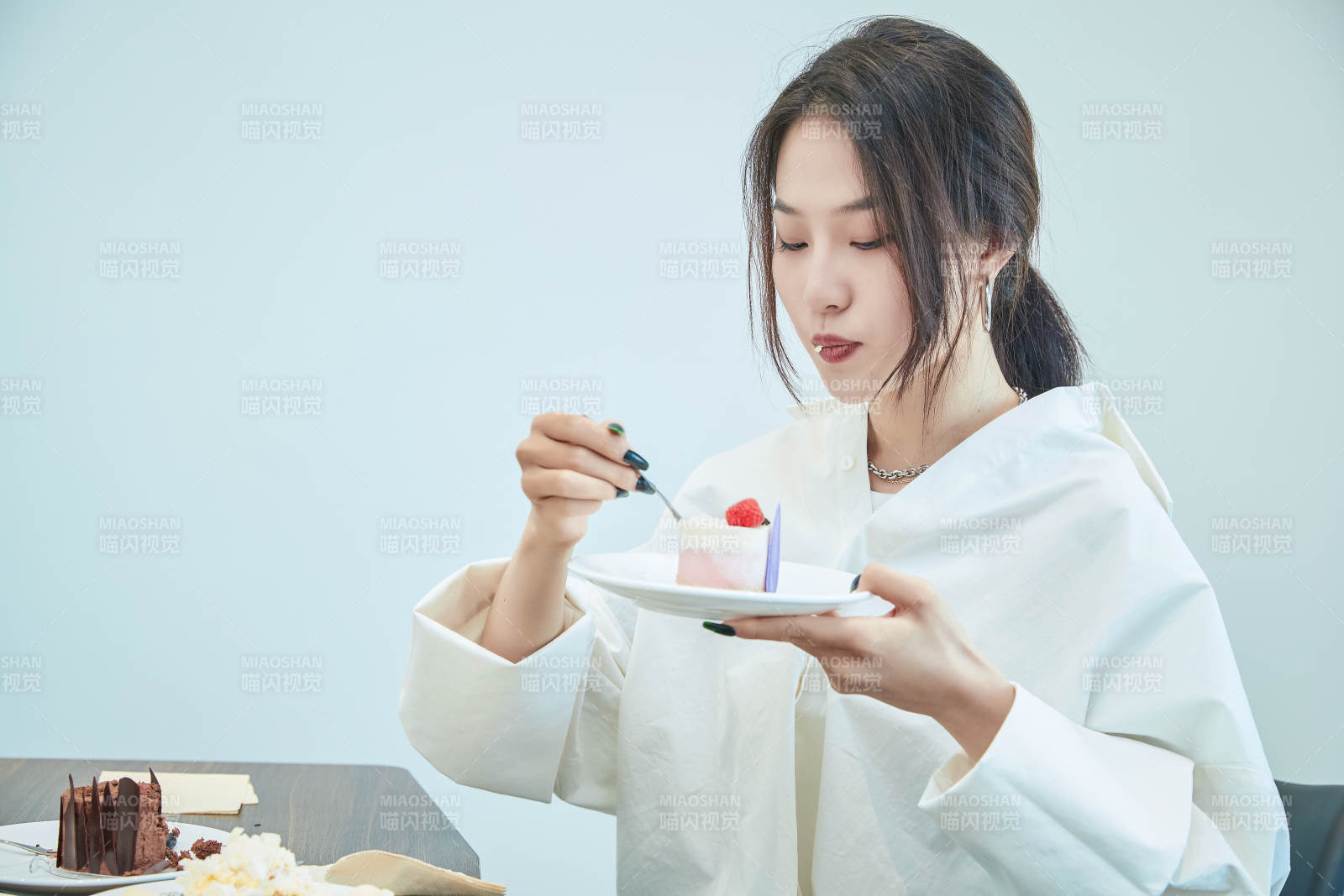 在烘焙店吃蛋糕喝饮料的可爱亚洲少女图片