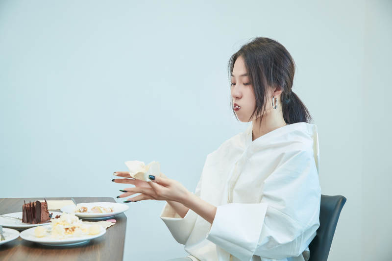 在烘焙店吃蛋糕喝饮料的可爱亚洲少女图片