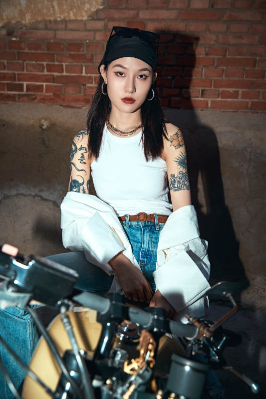 骑在复古摩托车上的时尚亚洲少女图片