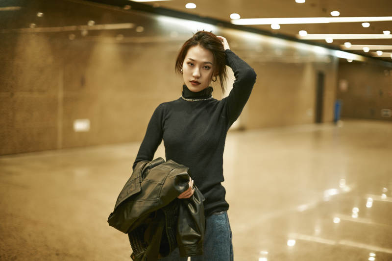 夜晚地下通道内停留的美丽少女图片