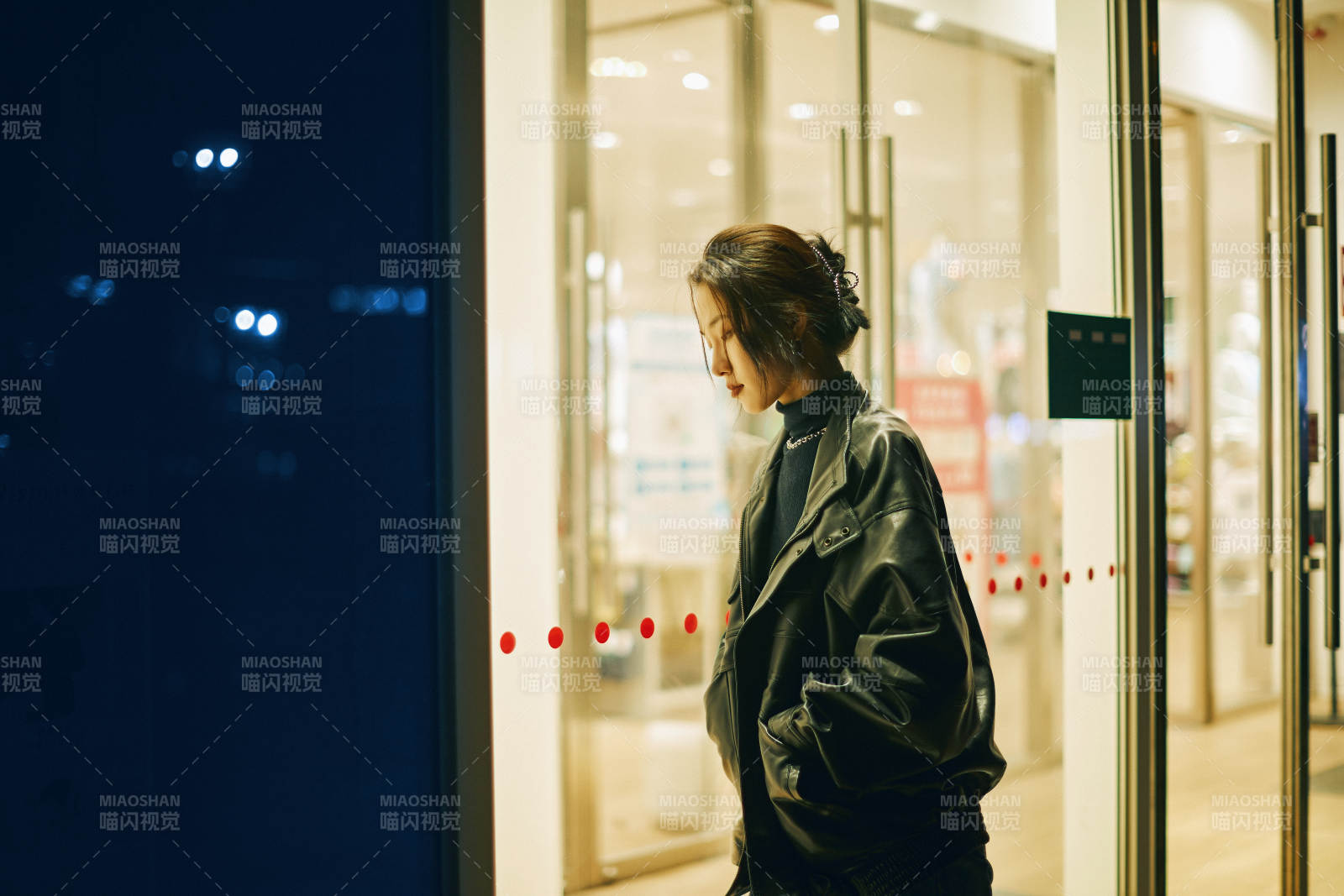 夜晚站立在橱窗外的亚洲少女图片