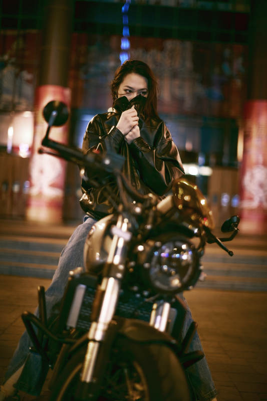 夜晚霓虹下骑摩托的少女图片