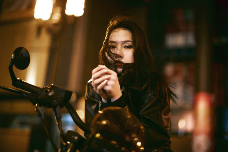 夜晚霓虹下骑摩托的少女图片
