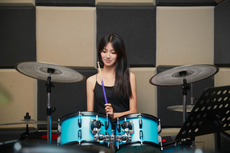在排练室打爵士鼓的亚洲少女图片