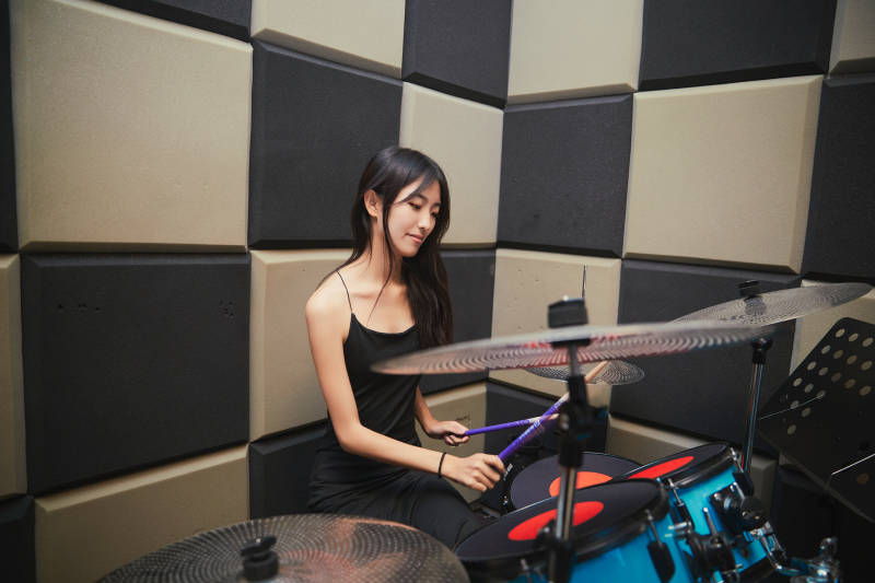 在排练室打爵士鼓的亚洲少女图片