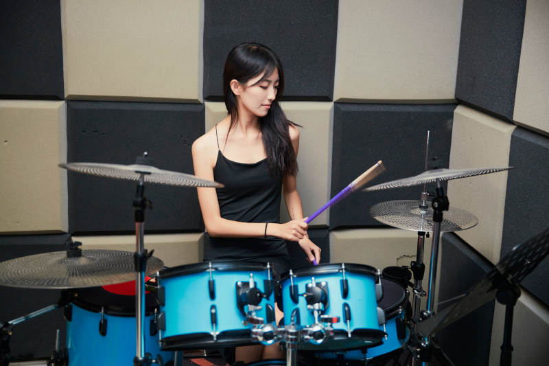 在排练室打爵士鼓的亚洲少女图片