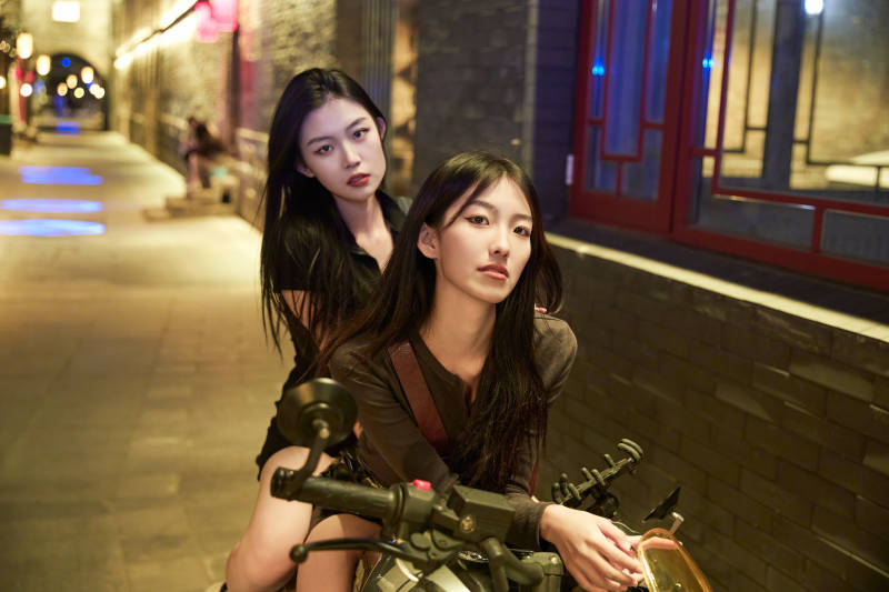 夜晚古城景区骑摩托的少女图片