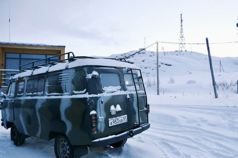 北极圈雪地中的迷彩面包车图片