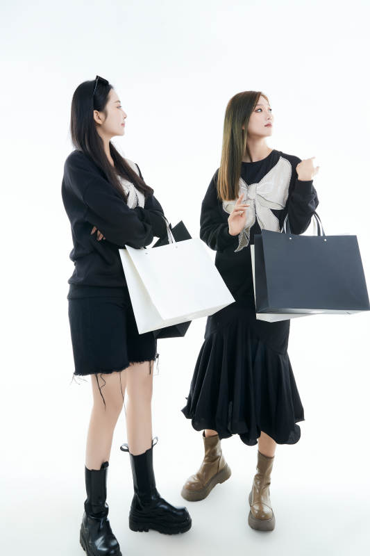 白色背景下手提购物袋时尚美丽的闺蜜图片