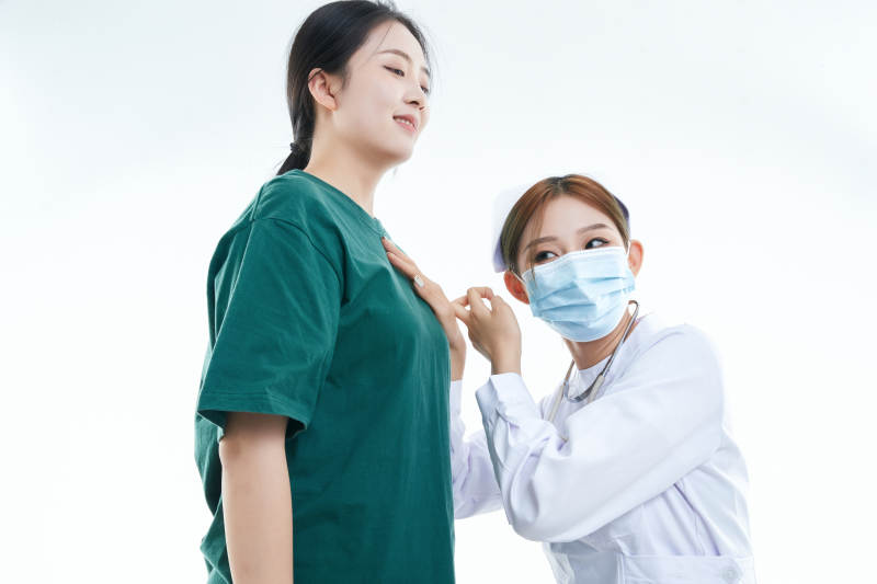 佩戴听诊器的女性医护人员为患者听诊检查图片