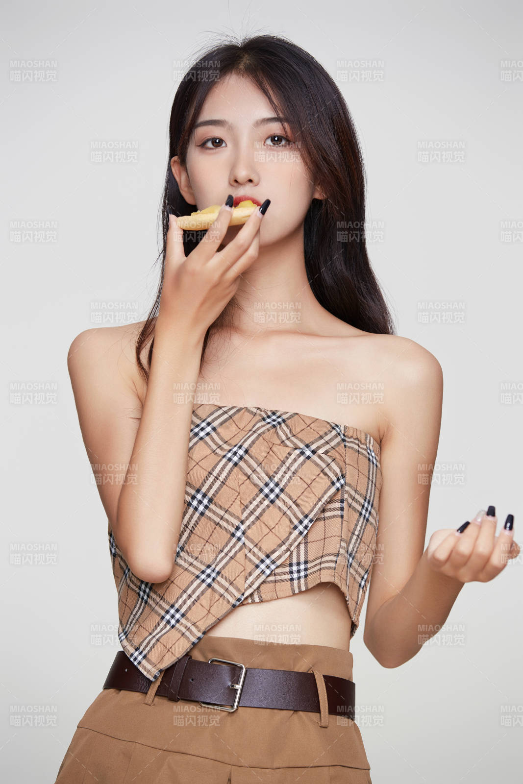 白色背景下吃着美味榴莲披萨的可爱少女图片