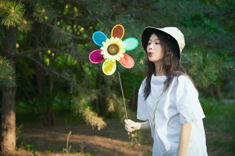手拿彩色风车玩耍的亚洲少女图片
