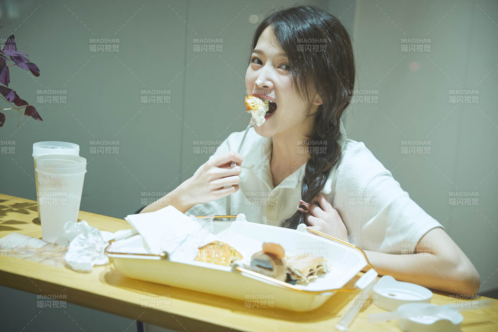 在烘焙店吃面包喝牛奶的可爱亚洲少女图片