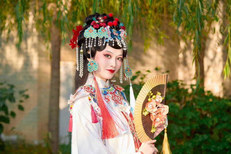 身穿国潮戏曲服饰装扮手拿花扇的中国美女图片