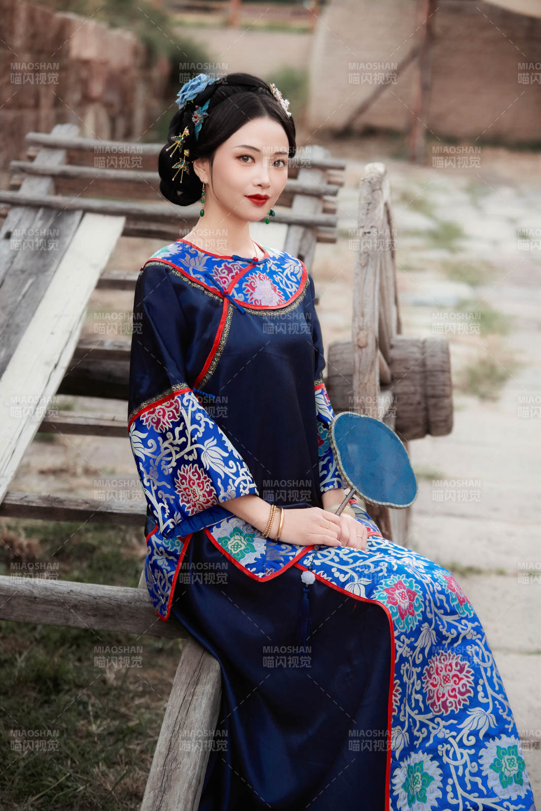 坐在古老手推车上的身穿晚清服饰的美女图片