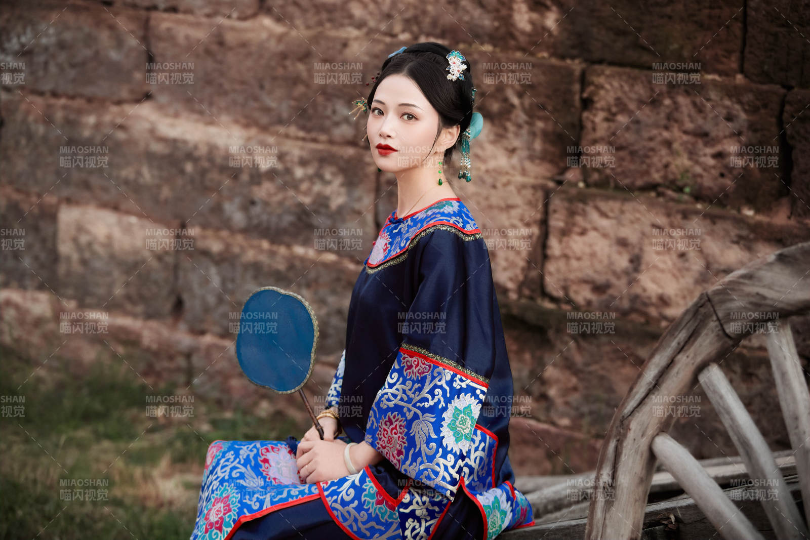 坐在古老手推车上的身穿晚清服饰的美女图片