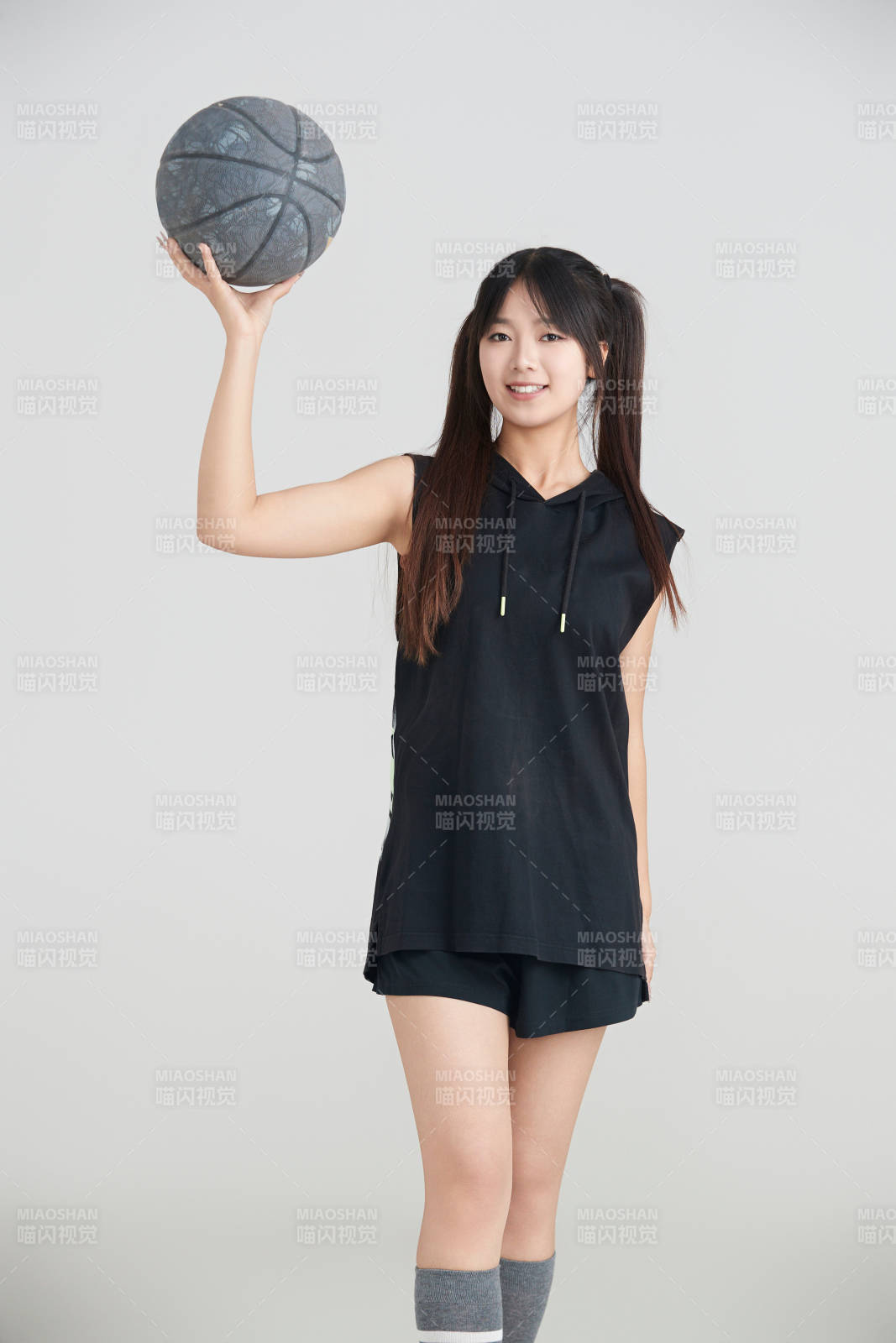 白色背景下的年轻女孩和篮球图片