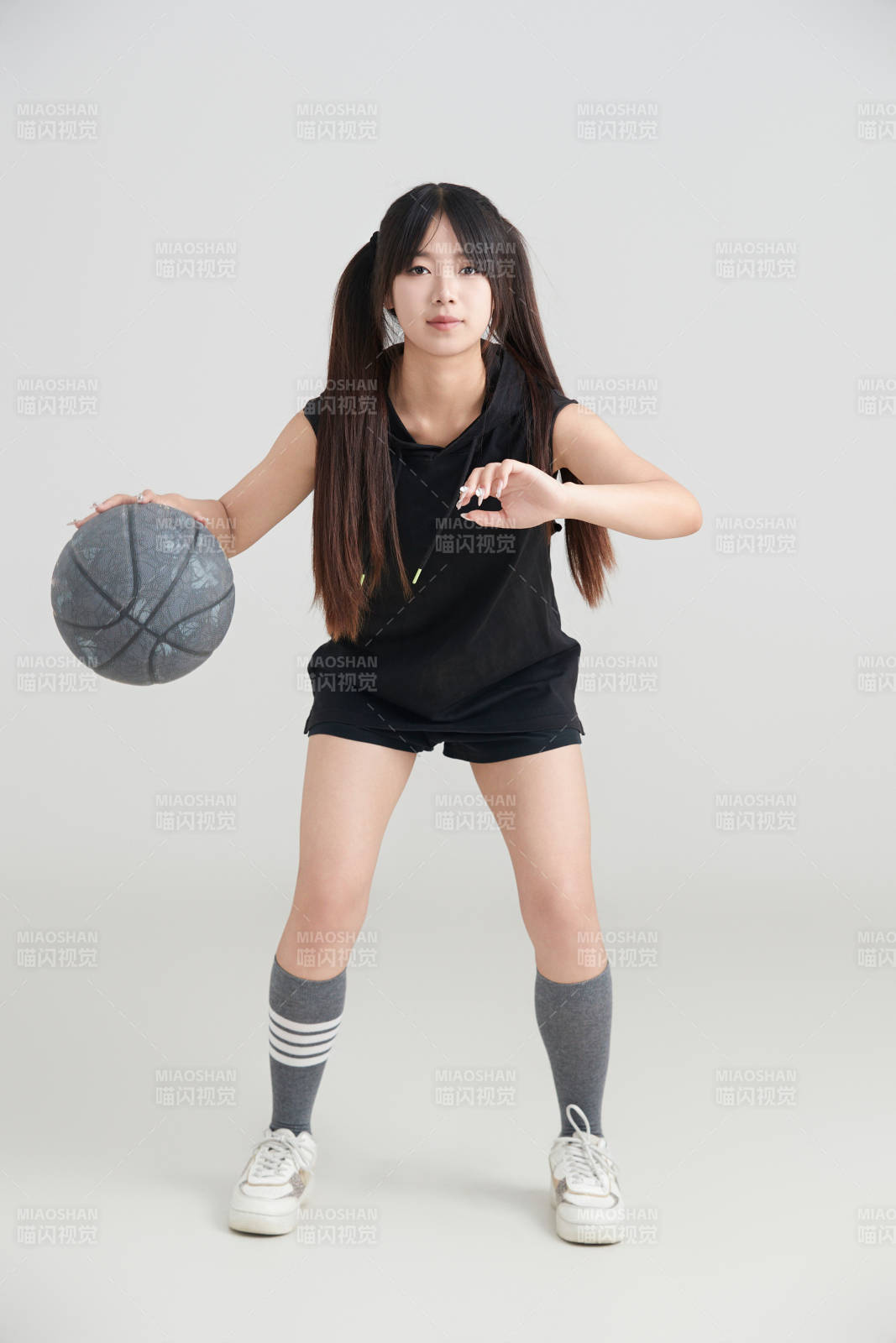 白色背景下的年轻女孩和篮球图片