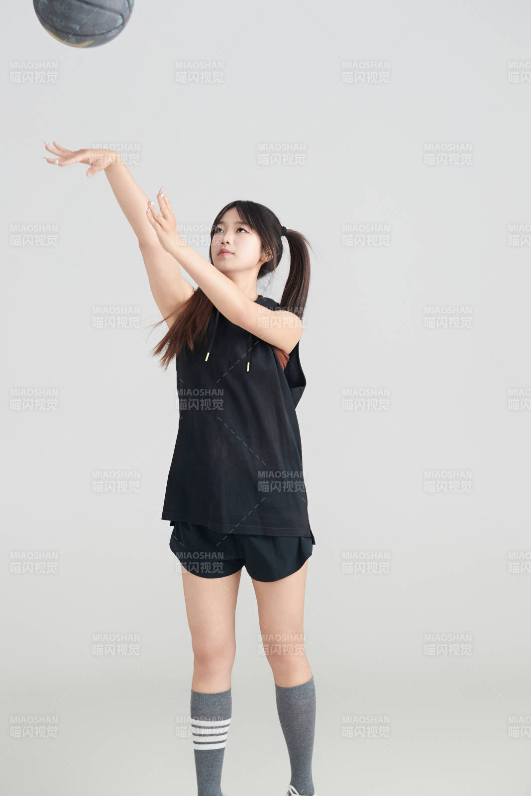 白色背景下的年轻女孩和篮球图片