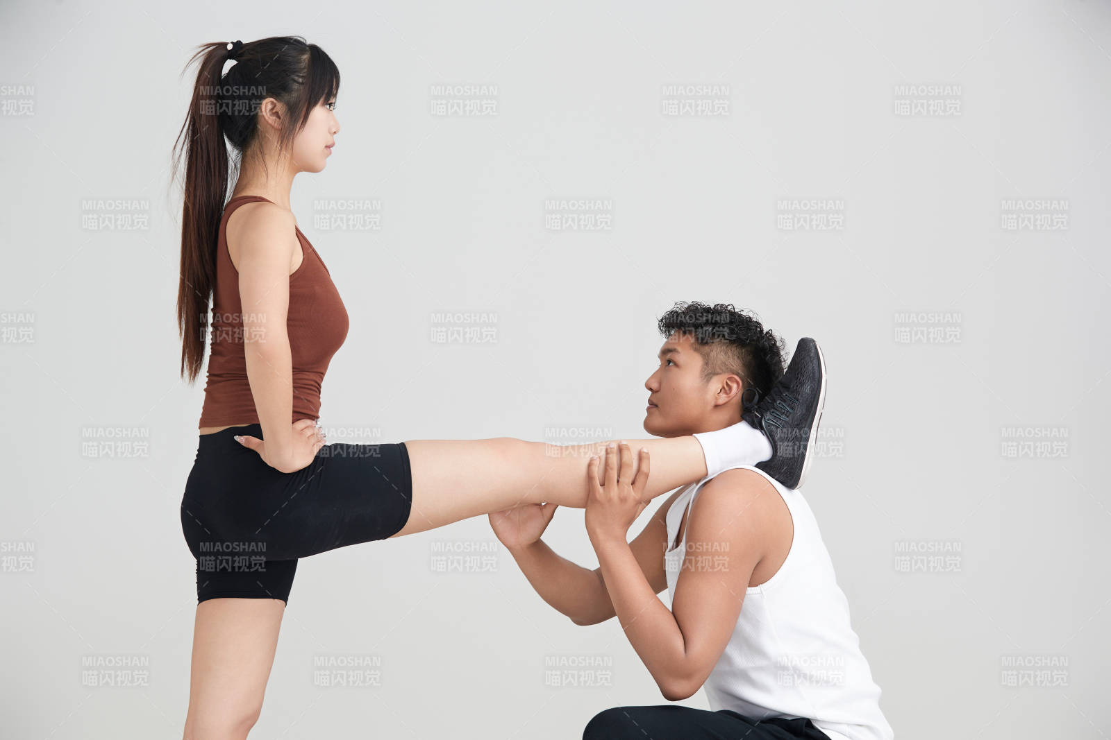 年轻女子在教练的指导下健身图片