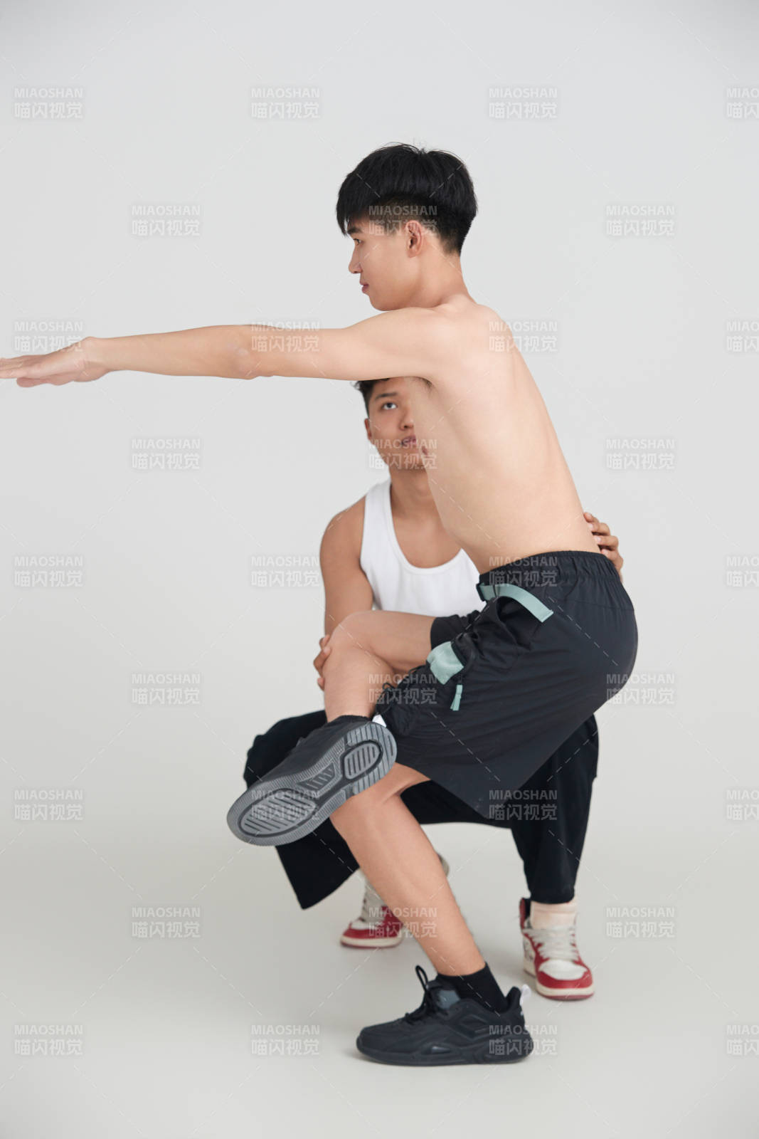 年轻男子在教练的指导下健身图片