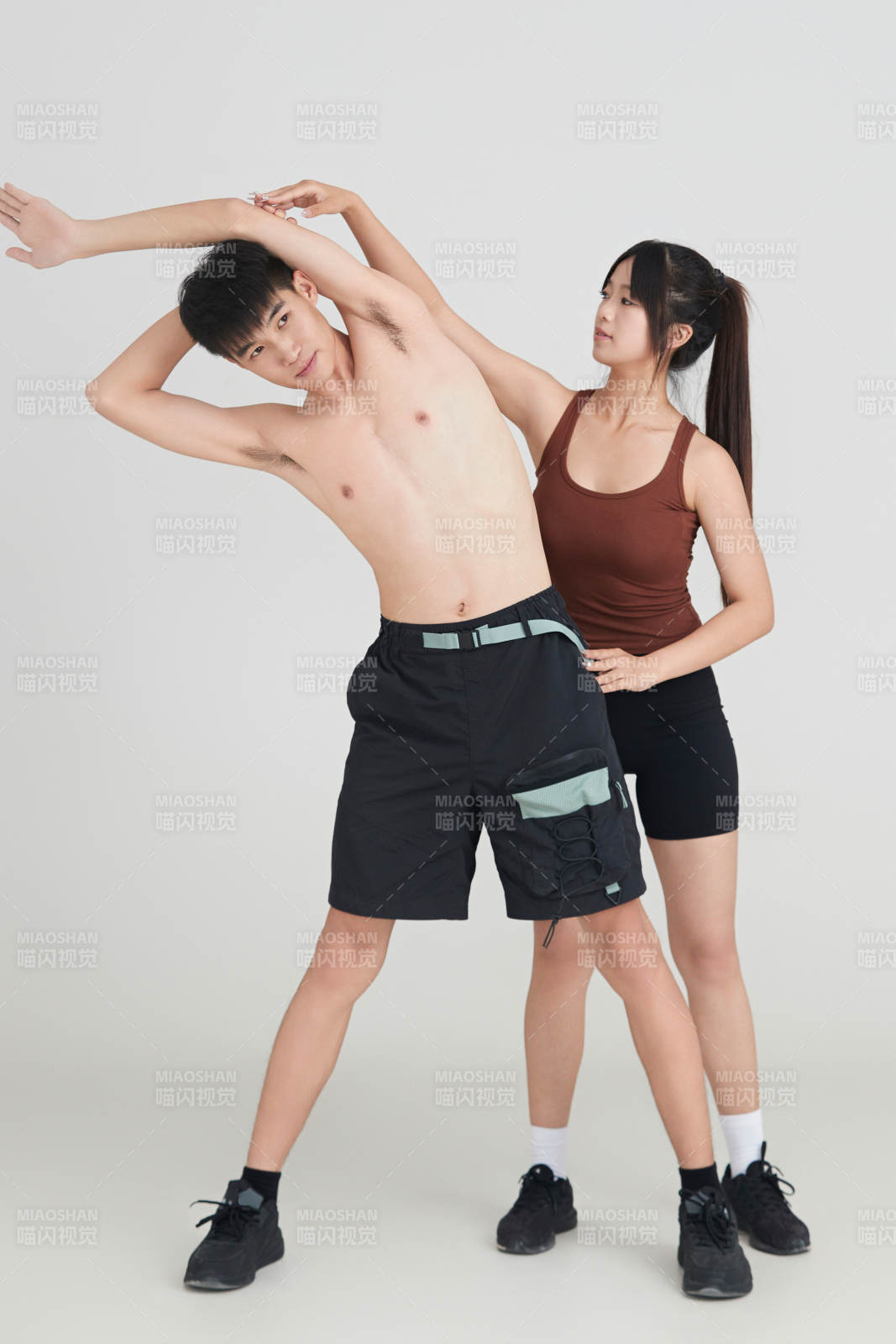 年轻男子在美女教练的指导下健身图片