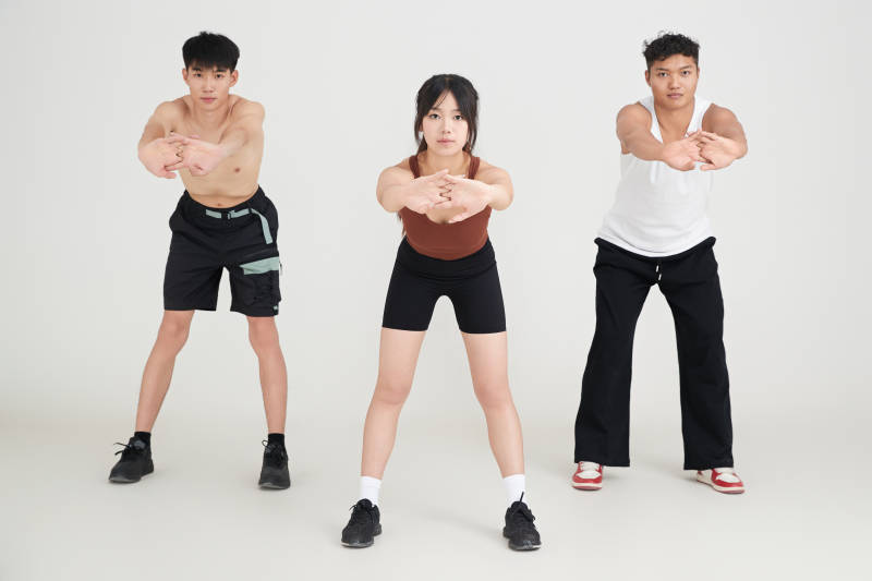 两名年轻男子在美女教练的带领下做健身操图片