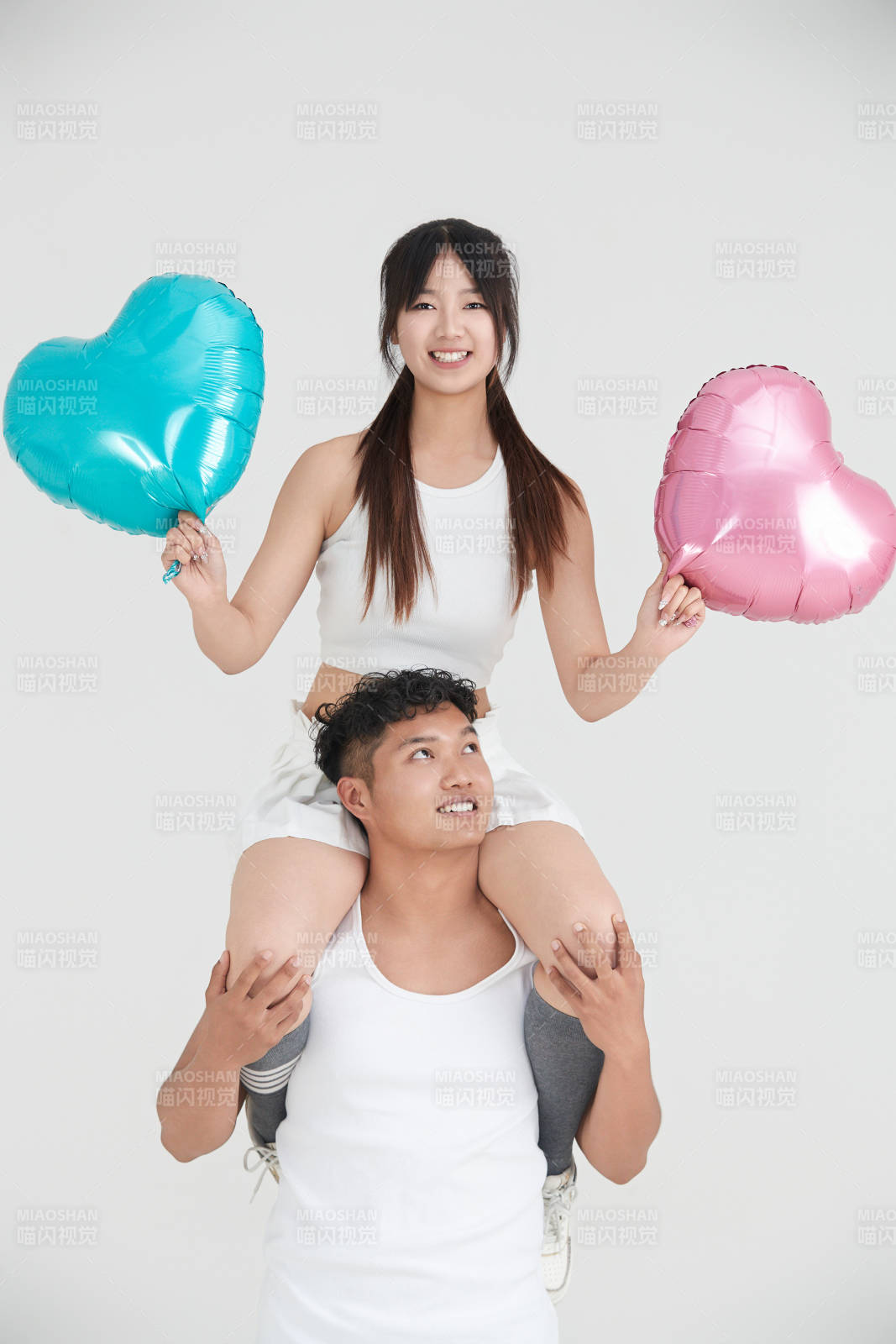 白色背景下嬉戏欢乐的亚洲情侣图片