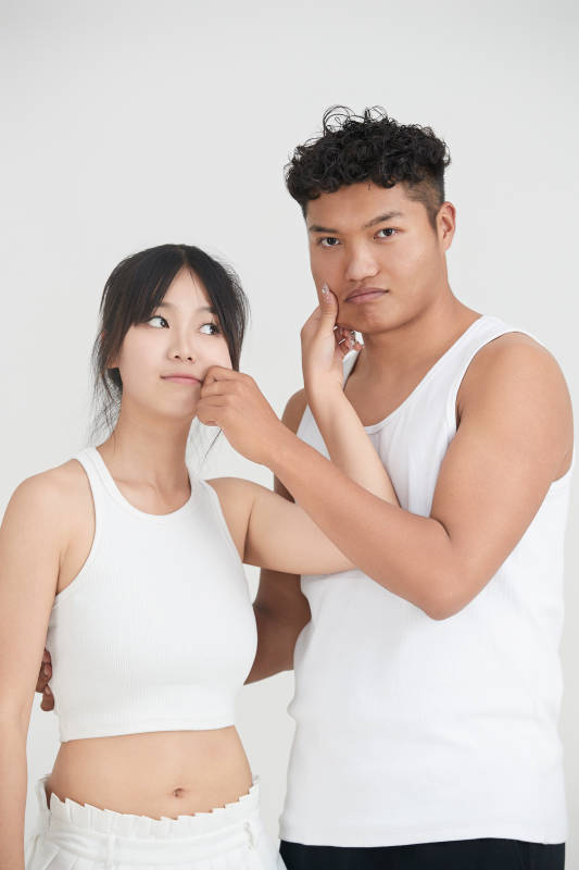 白色背景下嬉戏欢乐的亚洲情侣图片