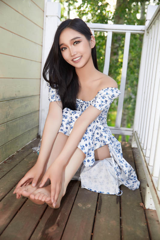 盛夏在别墅阳台上拍照的亚洲美女图片