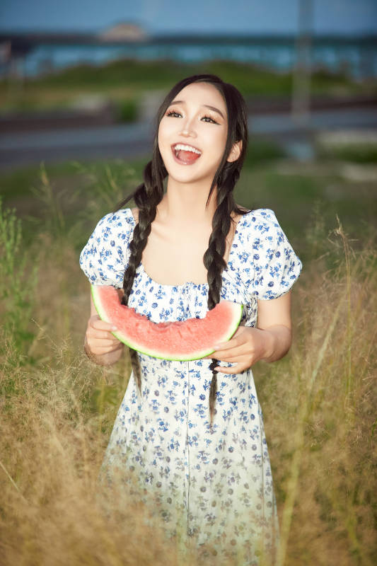 夏天在公园湖边开心吃西瓜的美女图片