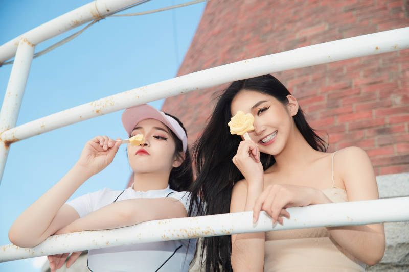 盛夏在景区湖边灯塔上拍照游玩的美女们图片