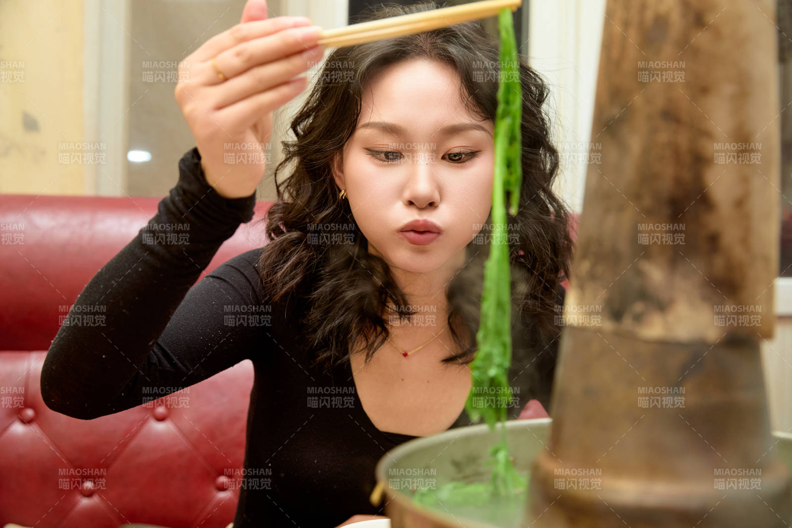 饭店吃传统铜锅涮肉的东方美女图片